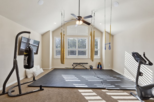 exercise room featuring ceiling fan, dark carpet, and lofted ceiling