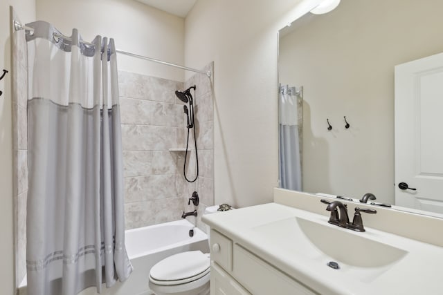 full bathroom with vanity, shower / bath combination with curtain, and toilet