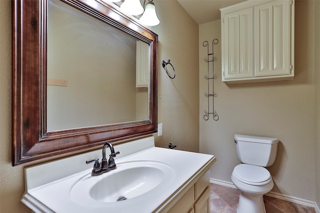 bathroom with vanity, toilet, and tile patterned flooring