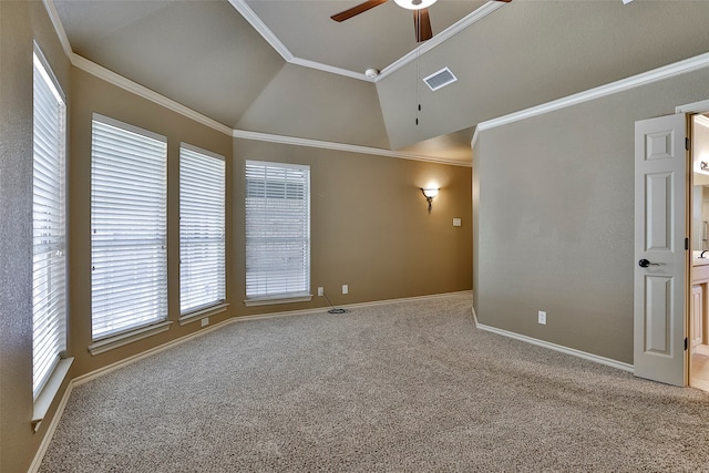 empty room featuring ornamental molding, ceiling fan, carpet flooring, and vaulted ceiling