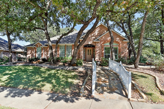 ranch-style home featuring a front yard