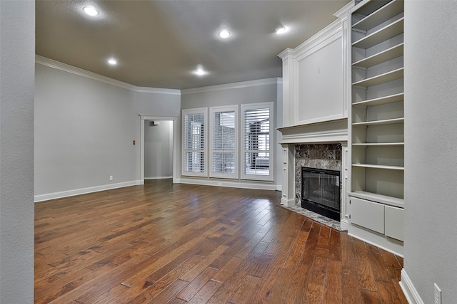 unfurnished living room with ornamental molding, dark hardwood / wood-style floors, and a high end fireplace