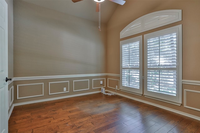 unfurnished room with dark wood-type flooring, ceiling fan, and vaulted ceiling