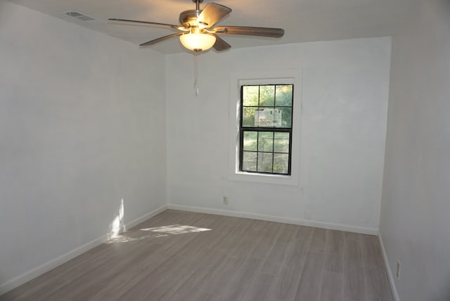 spare room with light hardwood / wood-style floors and ceiling fan