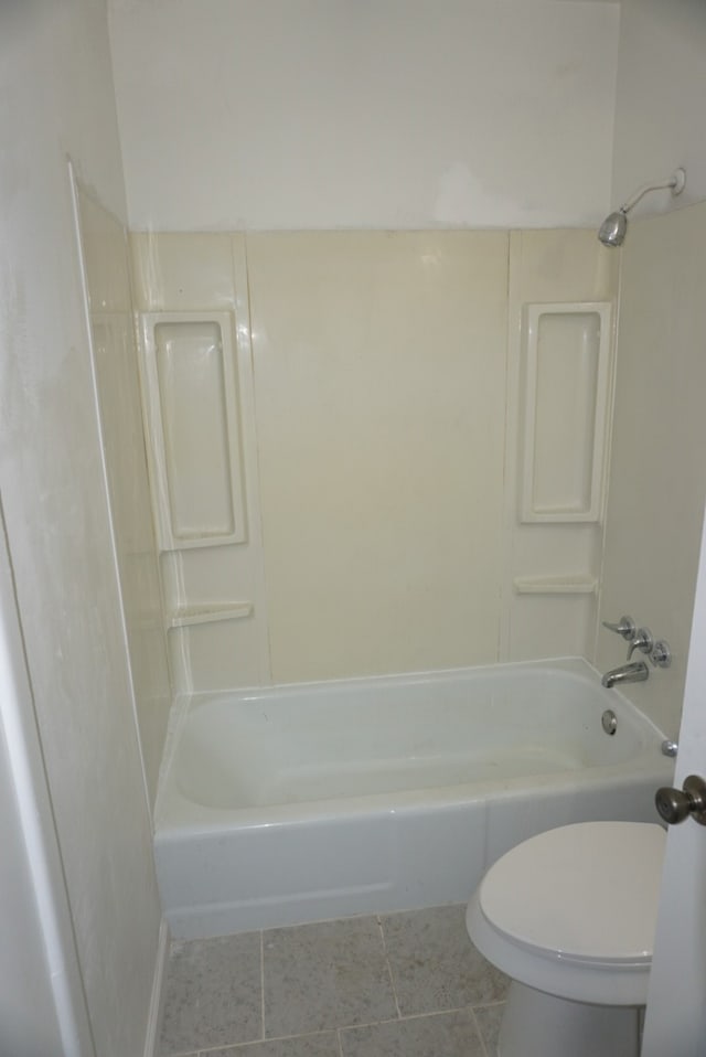 bathroom with toilet, tile patterned floors, and  shower combination