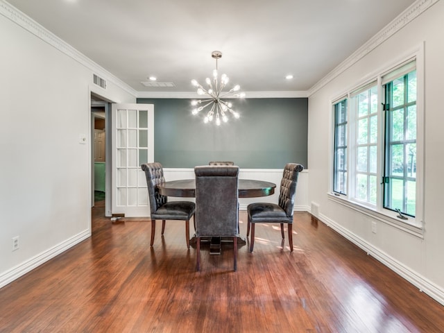 dining space featuring ornamental molding, dark wood-type flooring, and a chandelier