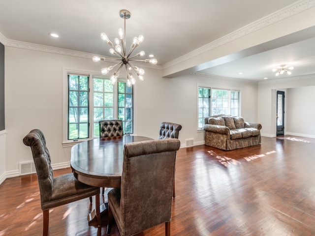 dining area featuring ornamental molding, a chandelier, and dark hardwood / wood-style flooring