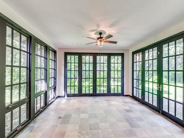 unfurnished sunroom with french doors and ceiling fan