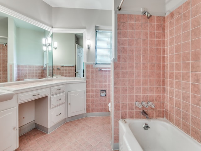 full bathroom featuring vanity, toilet, tile walls, and tiled shower / bath