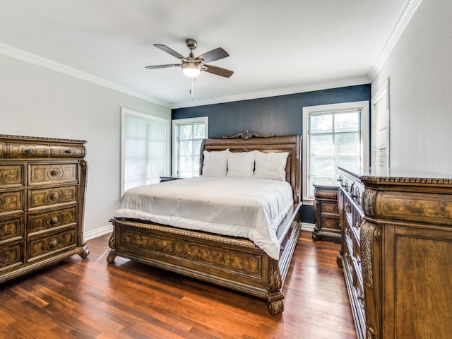 bedroom featuring ceiling fan, multiple windows, and dark hardwood / wood-style flooring