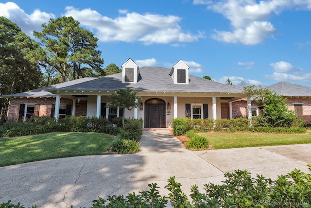 view of front of home with a porch and a front yard