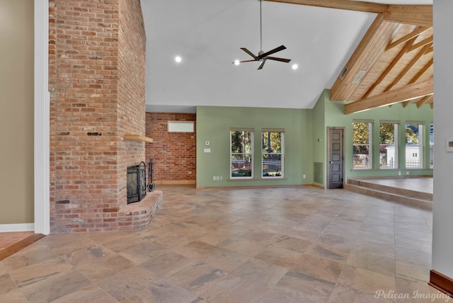 unfurnished living room featuring ceiling fan, a fireplace, high vaulted ceiling, and a wealth of natural light