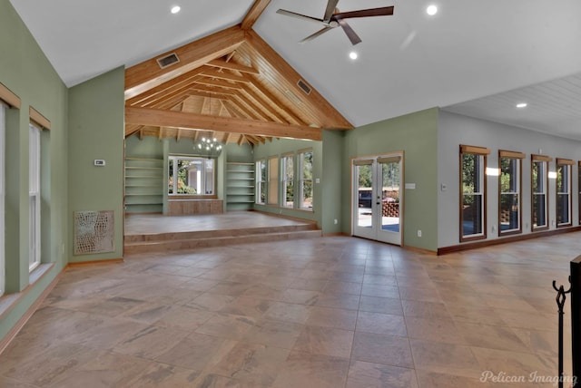 unfurnished living room featuring lofted ceiling, built in shelves, french doors, and ceiling fan