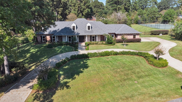 cape cod house with a front yard