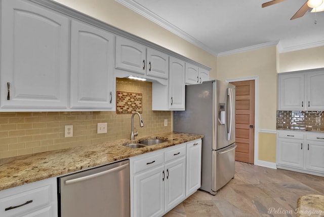 kitchen with white cabinetry, sink, light stone countertops, and appliances with stainless steel finishes