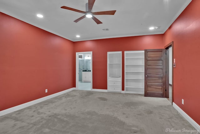 unfurnished bedroom with crown molding, ensuite bath, light colored carpet, and ceiling fan