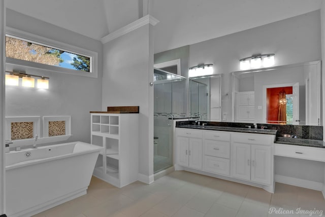 bathroom with vanity, shower with separate bathtub, tile patterned flooring, and vaulted ceiling