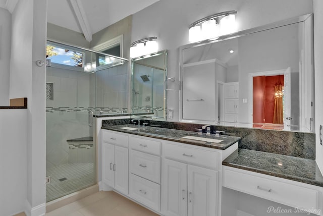 bathroom with vanity, a shower with shower door, and tile patterned floors