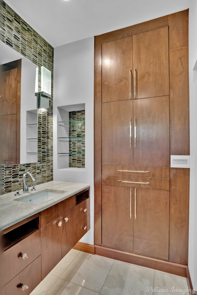 bathroom with tasteful backsplash and vanity