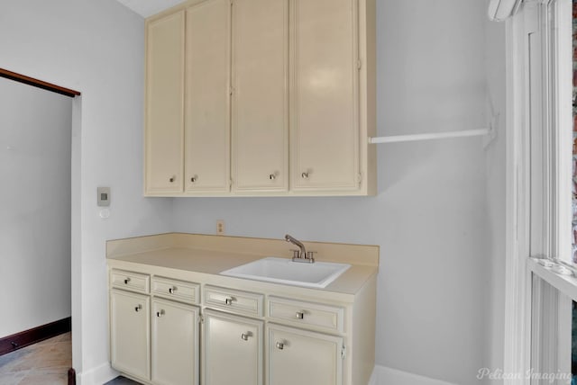 kitchen featuring sink, cream cabinets, and light tile patterned flooring