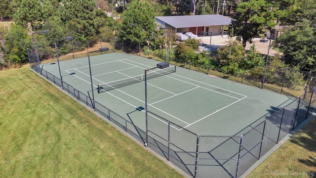 view of sport court with a yard