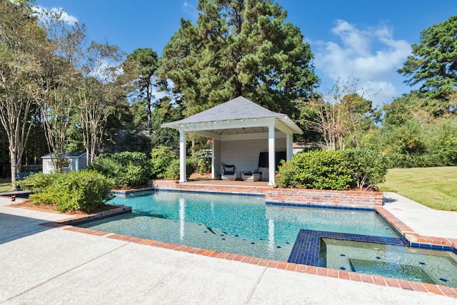 view of swimming pool with a storage shed, a gazebo, and a patio area