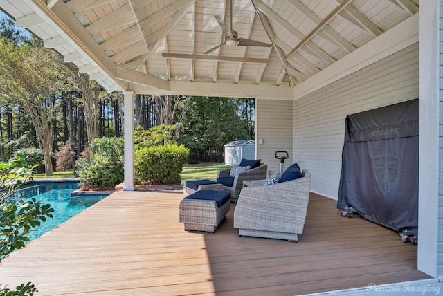 wooden deck featuring a gazebo, ceiling fan, and a shed