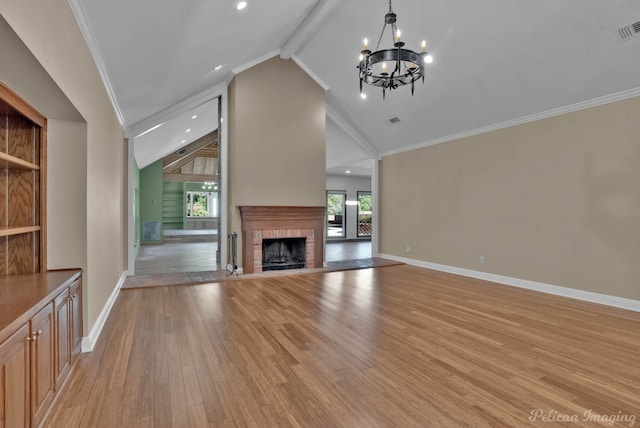 unfurnished living room with crown molding, a chandelier, high vaulted ceiling, a fireplace, and light hardwood / wood-style floors