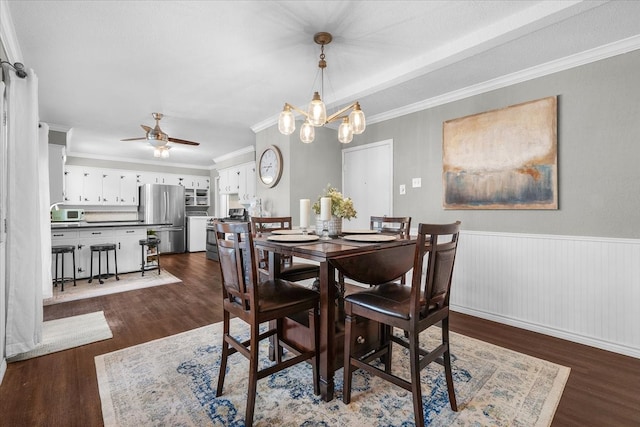 dining area featuring ceiling fan with notable chandelier, crown molding, and dark hardwood / wood-style floors