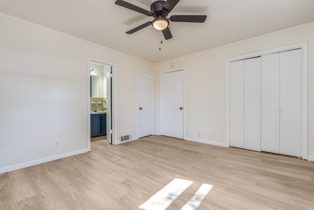 unfurnished bedroom featuring ornamental molding, light hardwood / wood-style flooring, ceiling fan, and ensuite bath