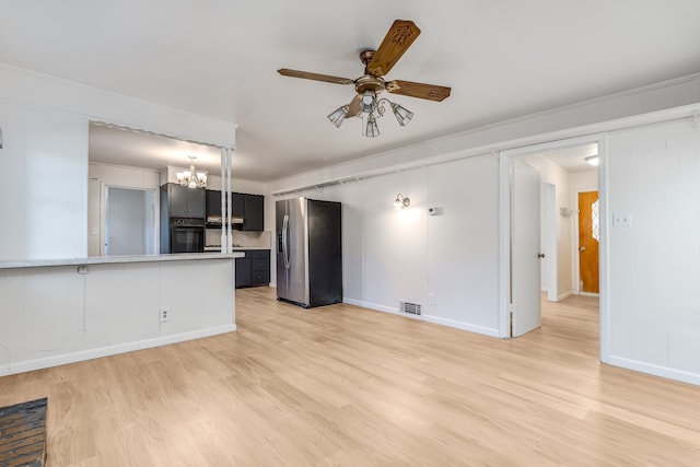 unfurnished living room with light hardwood / wood-style flooring, ceiling fan with notable chandelier, and crown molding