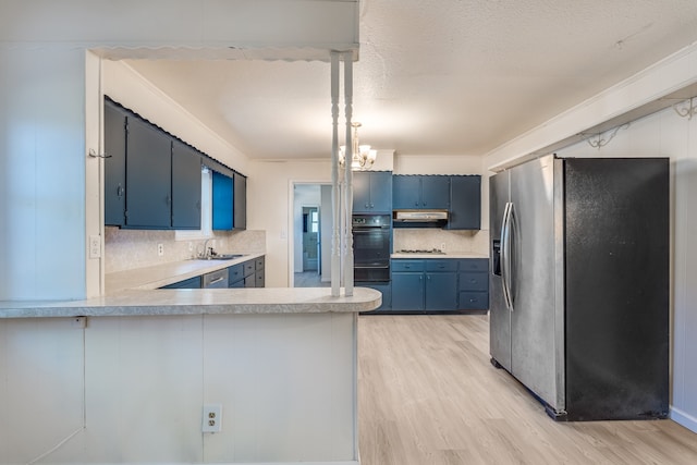 kitchen with kitchen peninsula, pendant lighting, blue cabinetry, decorative backsplash, and stainless steel refrigerator with ice dispenser