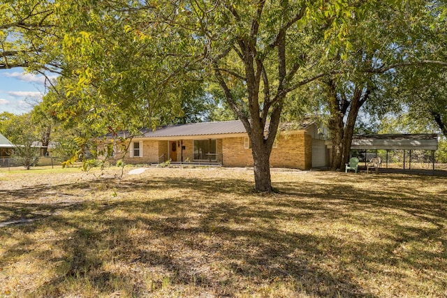 exterior space featuring a yard and a carport