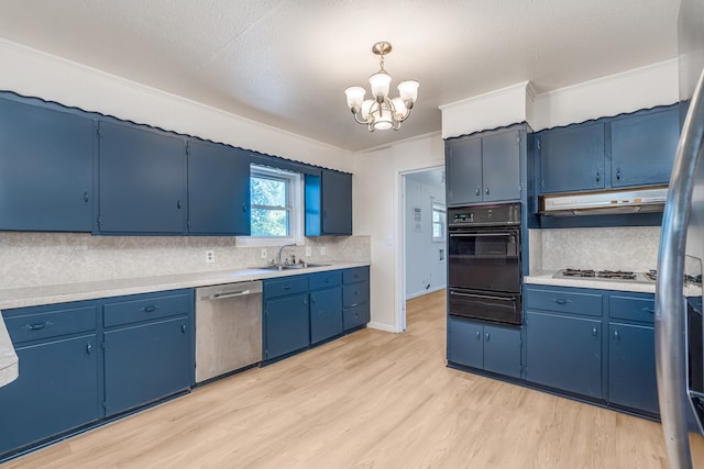 kitchen featuring stainless steel appliances, sink, pendant lighting, light hardwood / wood-style floors, and blue cabinets