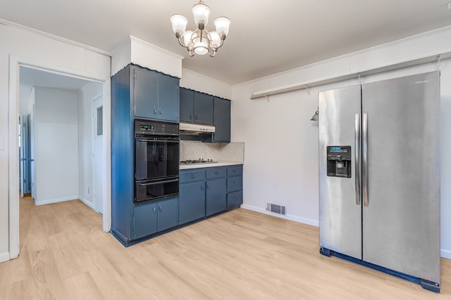 kitchen with tasteful backsplash, an inviting chandelier, blue cabinetry, light hardwood / wood-style flooring, and stainless steel appliances