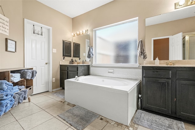 bathroom with vanity, a tub, and tile patterned floors