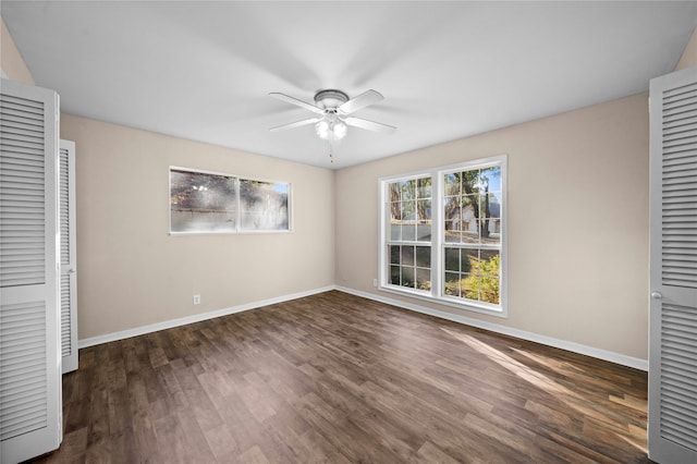 unfurnished bedroom with dark hardwood / wood-style flooring, a closet, and ceiling fan