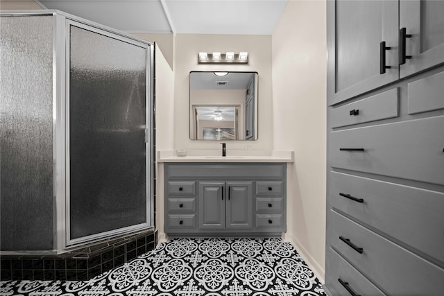 bathroom with vanity, a shower with shower door, and tile patterned flooring