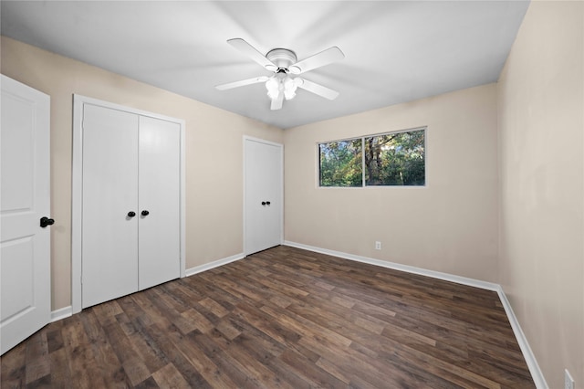 unfurnished bedroom with ceiling fan and dark hardwood / wood-style floors