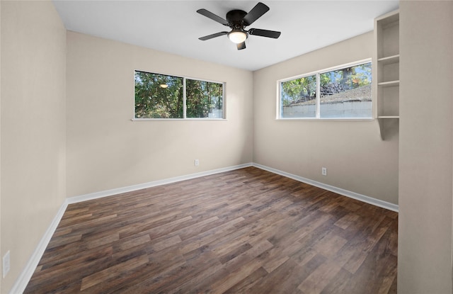 unfurnished room featuring ceiling fan and dark hardwood / wood-style flooring