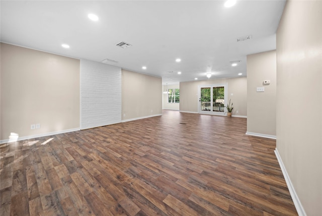 unfurnished living room with dark wood-type flooring