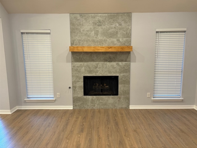 unfurnished living room with a fireplace and hardwood / wood-style floors