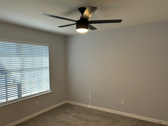 carpeted spare room with ceiling fan