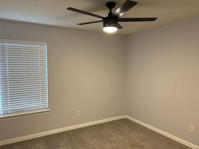 carpeted spare room featuring ceiling fan