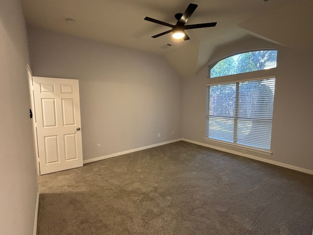 carpeted empty room with ceiling fan and vaulted ceiling