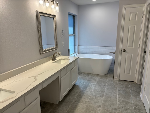 bathroom featuring vanity, tile walls, tile patterned floors, and a bath