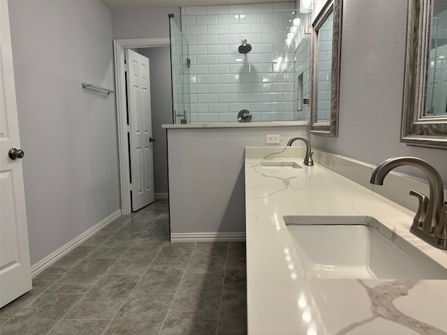 bathroom with vanity, tile patterned floors, and tiled shower