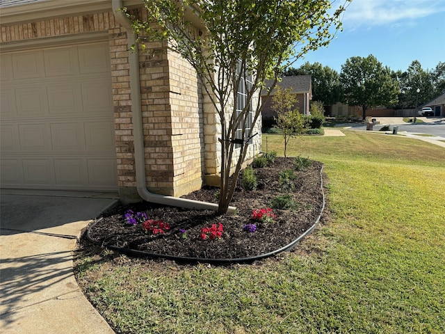 exterior space with a garage and a lawn