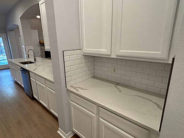 kitchen with white cabinets, stainless steel dishwasher, and sink