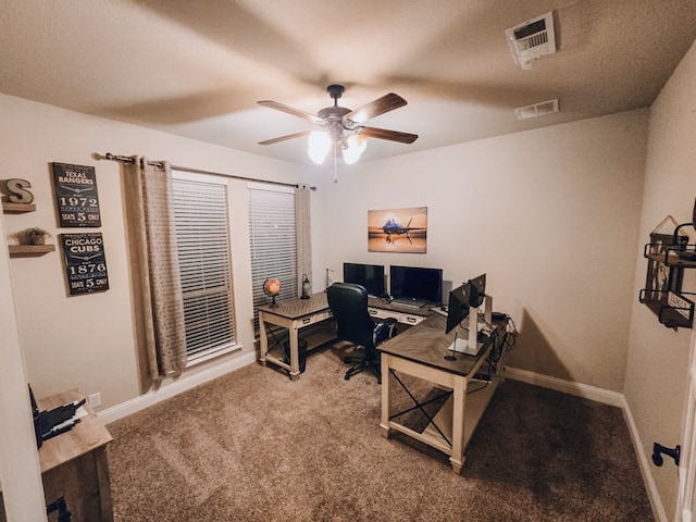 carpeted office space with ceiling fan